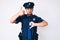 Young caucasian man wearing police uniform doing thumbs up and down, disagreement and agreement expression