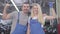 Young caucasian man and woman showing strength gesture, looking at camera and smiling. Professional auto mechanics in