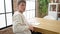 Young caucasian man writing on notebook sitting on table at dinning room