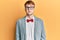 Young caucasian nerd man wearing glasses wearing hipster elegant look with bowtie with serious expression on face