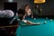 young caucasian pro billiard player finding best solution and right angle