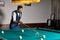 young caucasian pro billiard player finding best solution and right angle