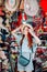 Young caucasian red hair woman tries on a hat while shopping at a store that sells wicker hats in Asian market in China