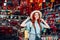 Young caucasian red hair woman tries on a hat while shopping at a store that sells wicker hats in Asian market in China