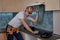 Young caucasian repairman checking work of kitchen hoods