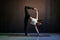 Young caucasian slim yoga girl doing variation of adho mukha shvanasana