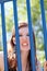 Young caucasian teen girl snarling through bars