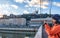 Young caucasian tourist take picture on the Passerelle du Palais de Justice cable-stayed pedestrian bridge, Lyon, France