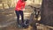 Young caucasian woman athlete tourist cyclist uses a hand tool, a bicycle pump to inflate air into a tire wheel mountain