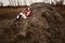 Young Caucasian woman in boots lying on a haystack