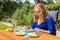 Young caucasian woman eating breakfast in garden