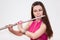 Young Caucasian woman flutist playing on flute,