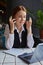 young caucasian woman in front of laptop, holding fingers crossed for good luck