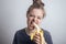 Young caucasian woman girl biting banana with funny face. Healthy lifestyle, fruit vegetarian diet.