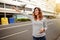 Young caucasian woman hailing a cab