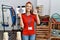 Young caucasian woman holding we need you banner hiring at retail shop doing ok sign with fingers, smiling friendly gesturing