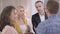 Young Caucasian woman introducing her groom to parents. Severe senior man and his positive blond wife acquainting with