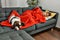 Young caucasian woman lying on sofa sleeping with dog at home