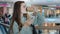 Young caucasian woman millennial girl standing indoors in mall business company looking at mobile phone reading message