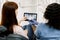 Young caucasian woman patient sitting in dentistry chair and looking on the tablet with teeth panoramic radiography