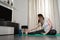 Young Caucasian woman practicing sport at home in a relaxed and smiling way