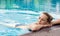 Young caucasian woman relaxing in swimming pool