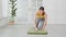 Young caucasian woman rolling with mat yoga on floor for preparation meditation and exercise for recreation.