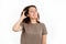 A young Caucasian woman is scratching her hair from dandruff and irritation. White background. The concept of hair care