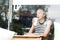 Young caucasian woman sitting alone in coffee shop thoughtfully leaning on her hand, looking trough the window