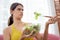 Young caucasian woman sitting on sofa eating vegetable salad while feeling dislike and expression disgusted.