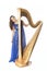 Young caucasian woman stands with concert harp in studio against