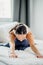 Young caucasian woman stretch legs doing yoga