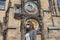 Young Caucasian woman with sunglasses and medical face mask photographed in front of the Astronomical clock Orloj in Prague, Czech