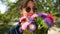 young caucasian woman in sunglasses sniffs a bouquet of flowers. slowmo video