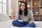 Young caucasian woman talking on smartphone sitting on bed at bedroom