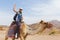 Young caucasian woman tourist riding on camel