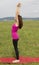 Young caucasian woman in upward salute pose during yoga in nature
