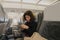 Young Caucasian woman use mobile phone inside airplane sitting