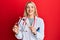 Young caucasian woman wearing doctor uniform holding tuning fork smiling with a happy and cool smile on face