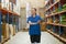 Young caucasian woman worker use tablet technology checking stock in warehouse cargo goods storage. Products Inventory management