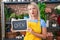 Young caucasian woman working at florist holding open sign clueless and confused expression