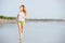 Young caucasion woman running on the beach at