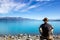 Young causacian man enyoing view of Lake Pukaki with Mt Cook as a Background, South Island New Zealand ,Summertime