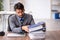 Young chained male employee sitting in the office