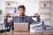 Young chained male employee sitting in the office