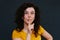 Young charismatic caucasian woman showing silence sign on the grey background.