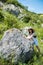 Young charm woman on a stone enjoying in landscape