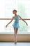 Young charming ballerina in ballet studio.