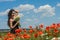 Young charming brunette girl with a bouquet of white field chamomiles on a summer sunny day