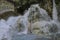 Young charming girl bathes in the healing thermal mineral springs in the resort of Saturnia Italy